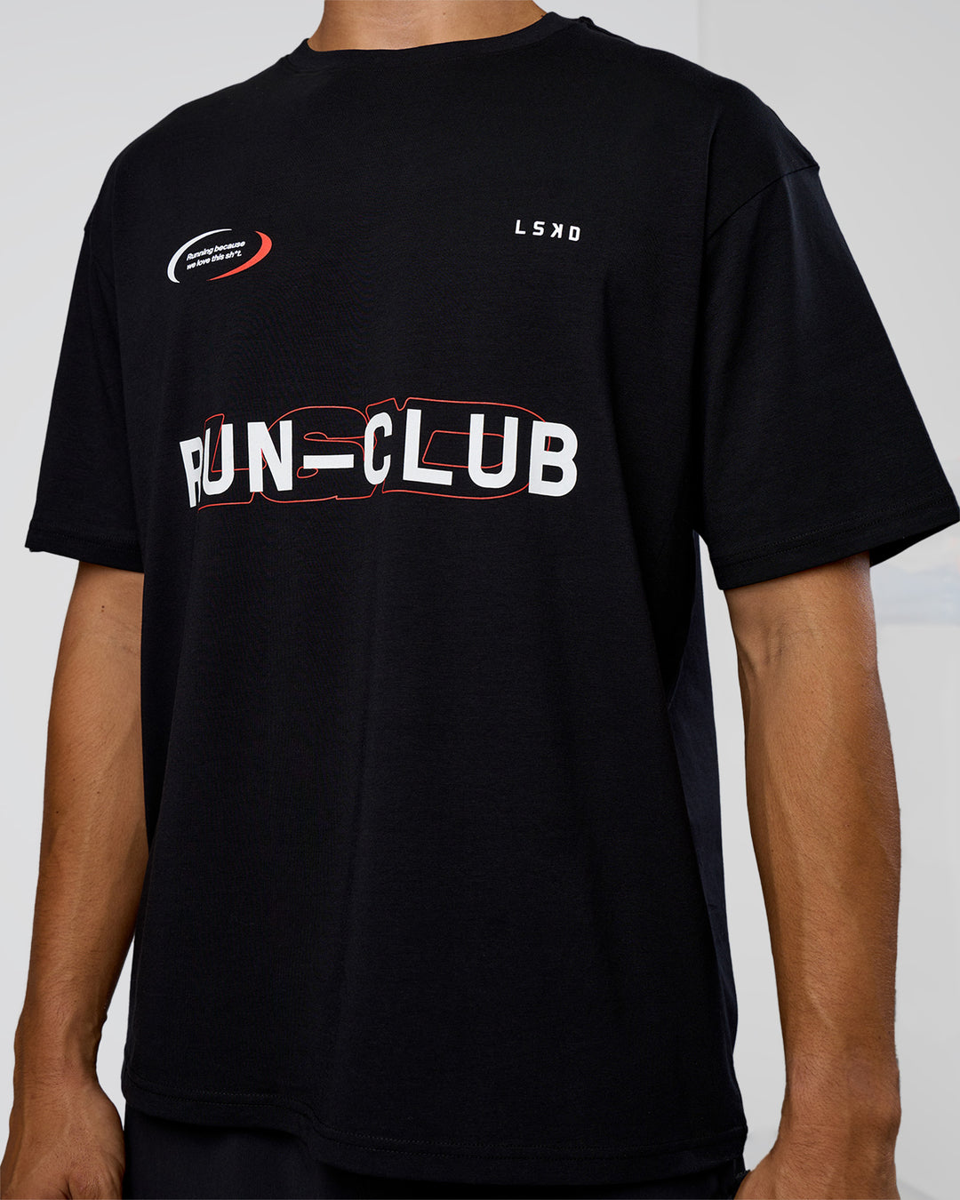 Man wearing LSKD Run Club FLXCotton Oversized Tee - Black-White | Model:Jackson | Size:L