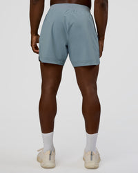 Man wearing Lift 6" Short - Dusty Blue | Model:Sam | Size:L