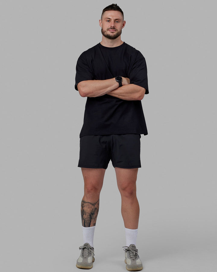 Man wearing Unisex Lifting Club FLXCotton Tee Oversize - Black-White-Yellow
