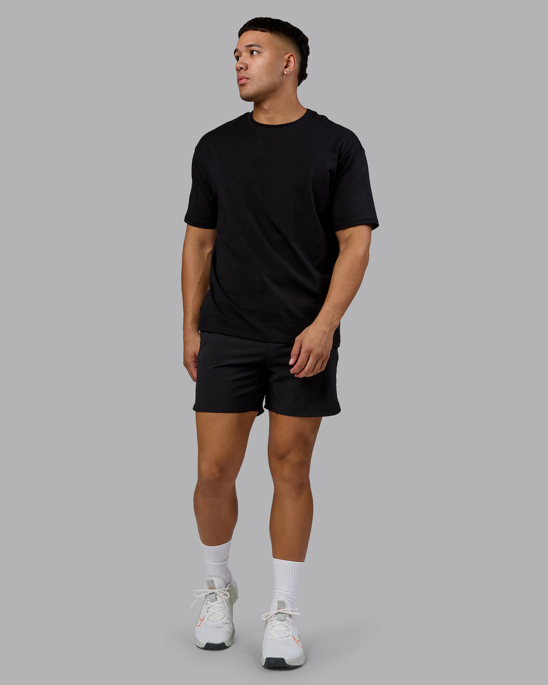 Man wearing Lifting Club FLXCotton Tee Oversize - Black-Ultra Orange | Model:Kaelyb | Size:L
