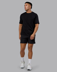 Man wearing Lifting Club FLXCotton Tee Oversize - Black-Ultra Orange | Model:Kaelyb | Size:L
