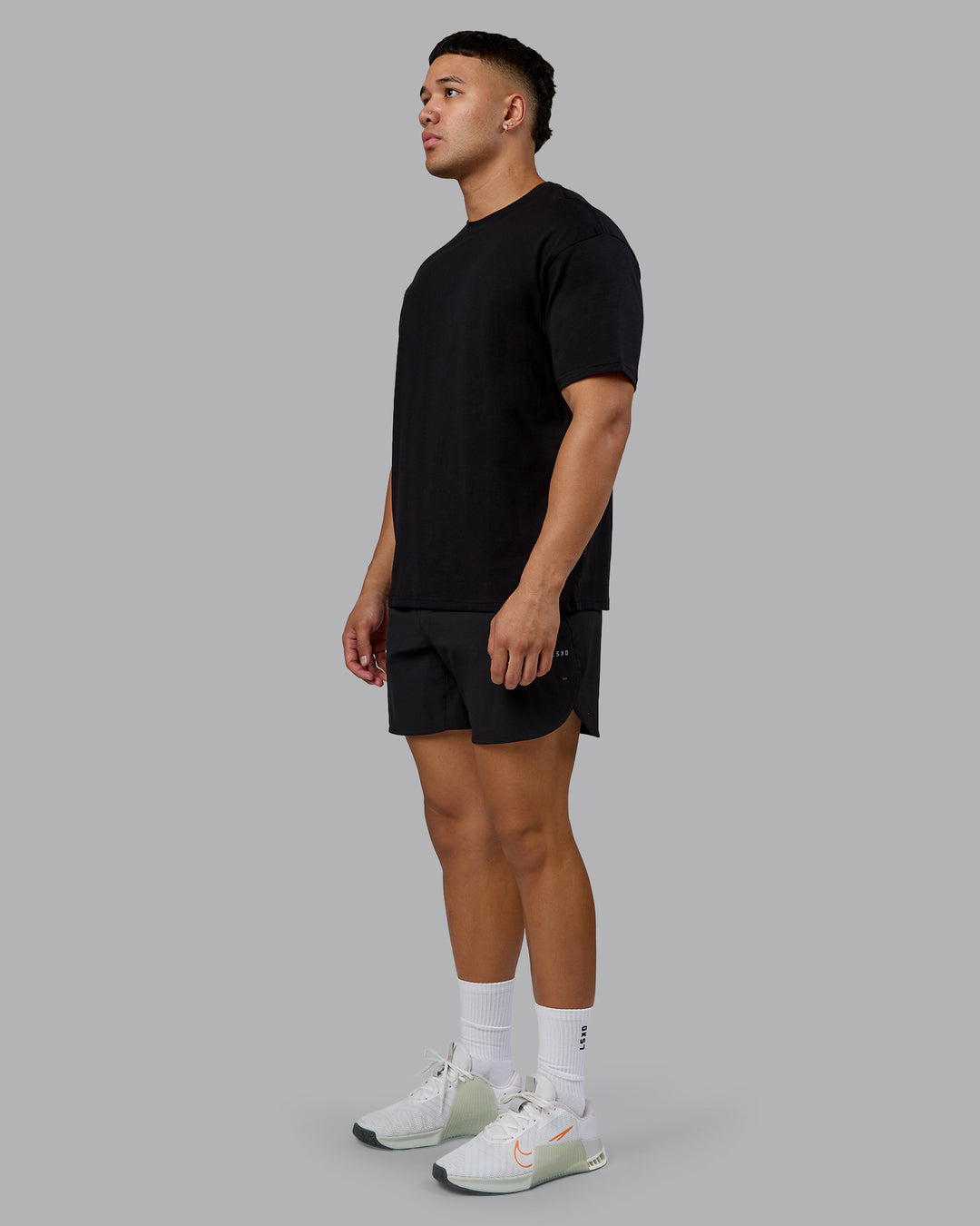 Man wearing Lifting Club FLXCotton Tee Oversize - Black-Ultra Orange | Model:Kaelyb | Size:L