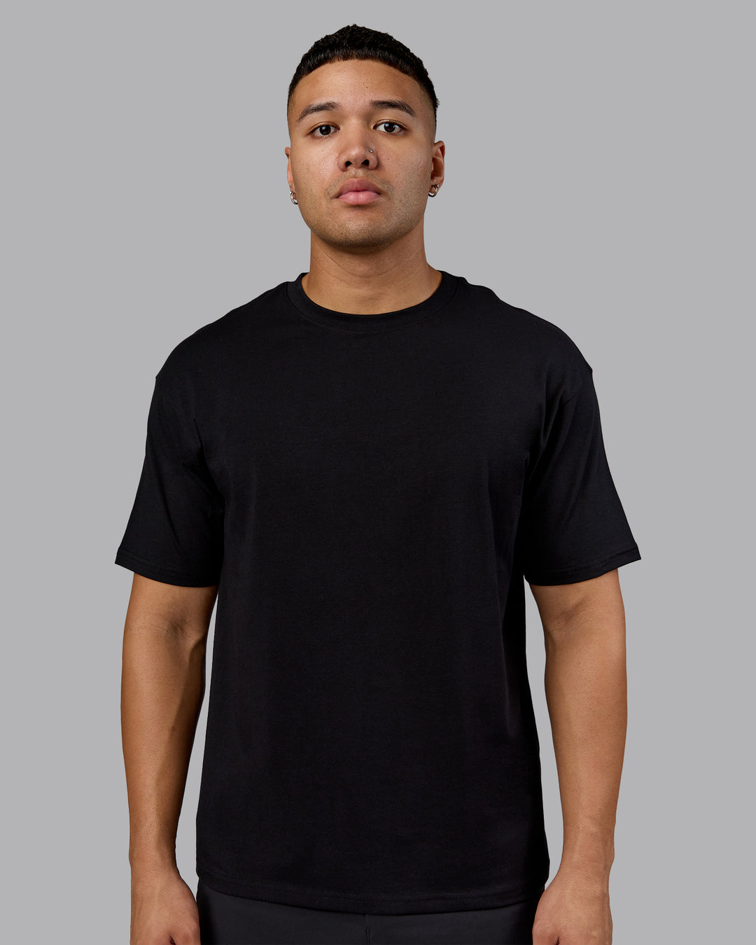 Man wearing Lifting Club FLXCotton Tee Oversize - Black-Ultra Orange | Model:Kaelyb | Size:L