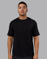 Man wearing Lifting Club FLXCotton Tee Oversize - Black-Ultra Orange | Model:Kaelyb | Size:L