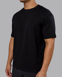 Man wearing Lifting Club FLXCotton Tee Oversize - Black-Ultra Orange | Model:Kaelyb | Size:L