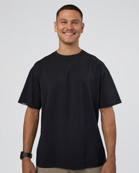 Man wearing Lifting Club FLXCotton Tee Oversize - Black-Black | Model:Nikola | Size:L