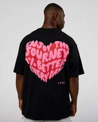 Man wearing Love the Journey FLXCotton Oversized Tee - Black-Flame | Model:Sam | Size:L