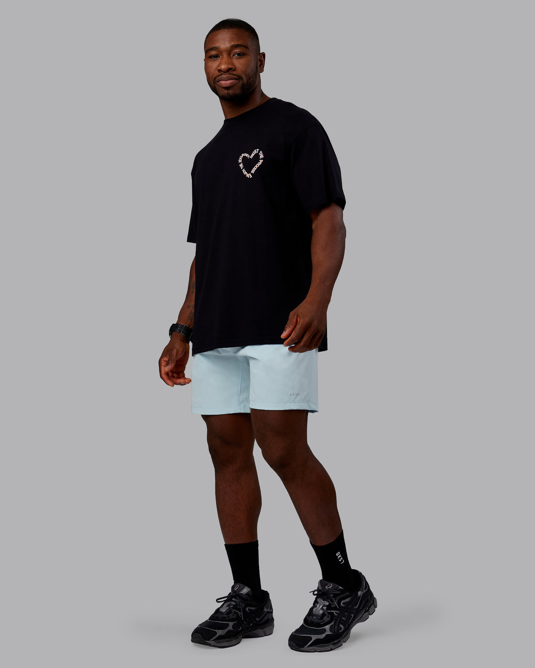 Man wearing Love The Process FLXCotton Oversize Tee - Black-Peach Fuzz | Model:Sam | Size:L