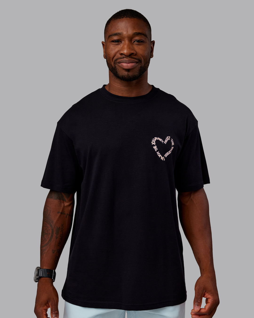 Man wearing Love The Process FLXCotton Oversize Tee - Black-Peach Fuzz | Model:Sam | Size:L