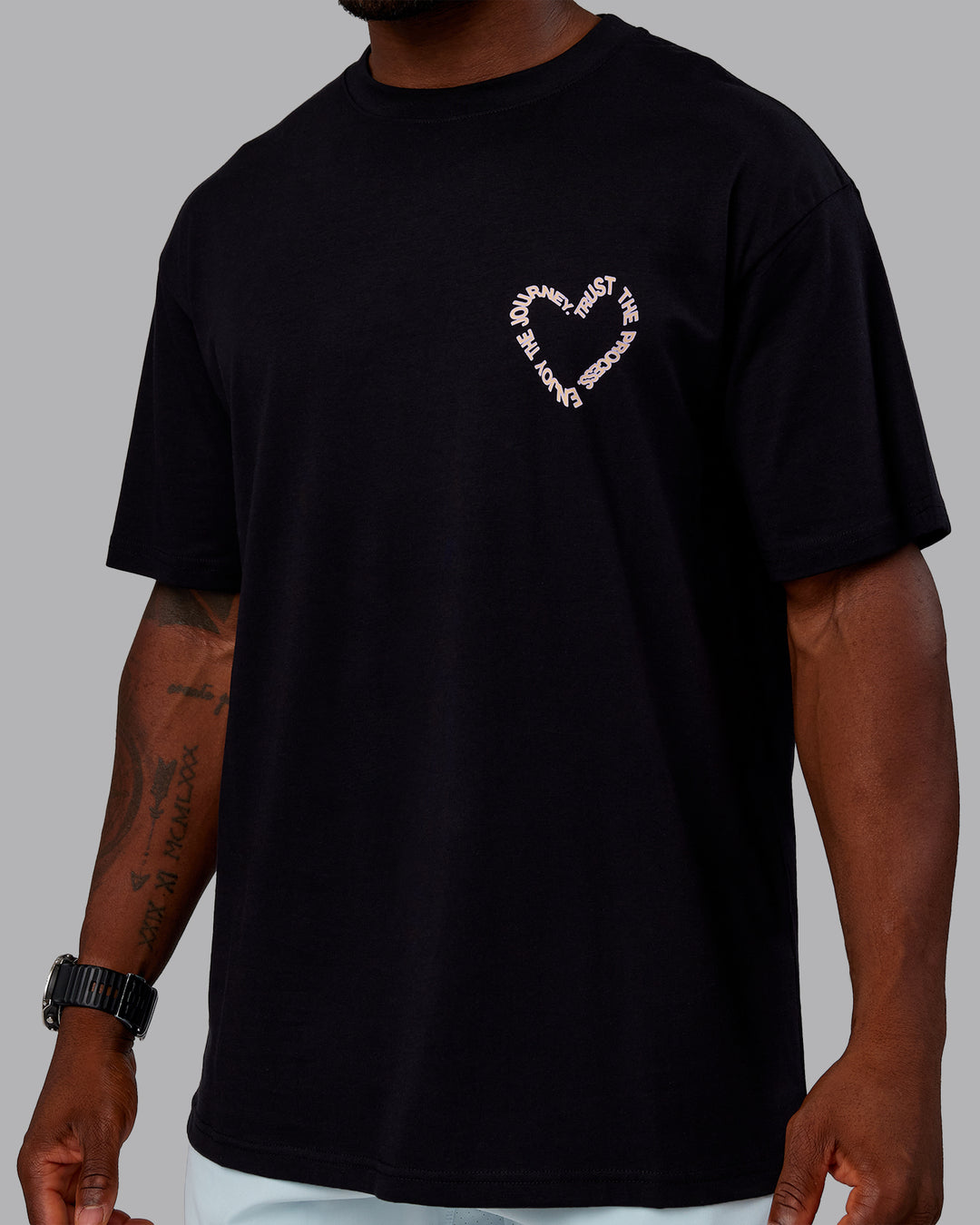 Man wearing Love The Process FLXCotton Oversize Tee - Black-Peach Fuzz | Model:Sam | Size:L