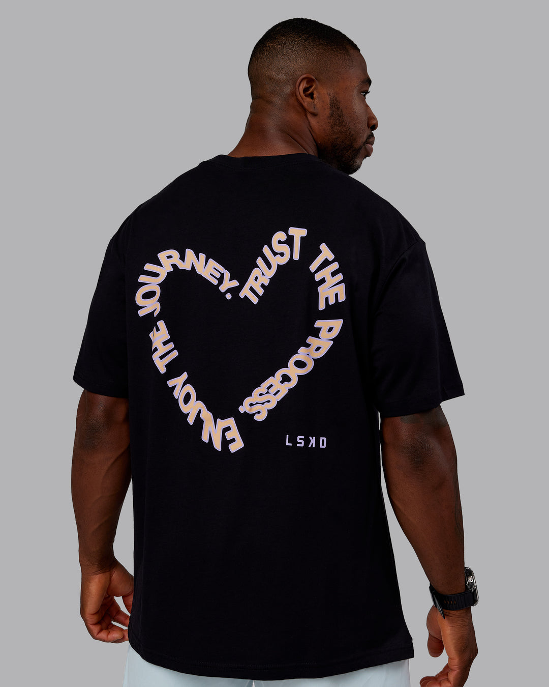Man wearing Love The Process FLXCotton Oversize Tee - Black-Peach Fuzz | Model:Sam | Size:L