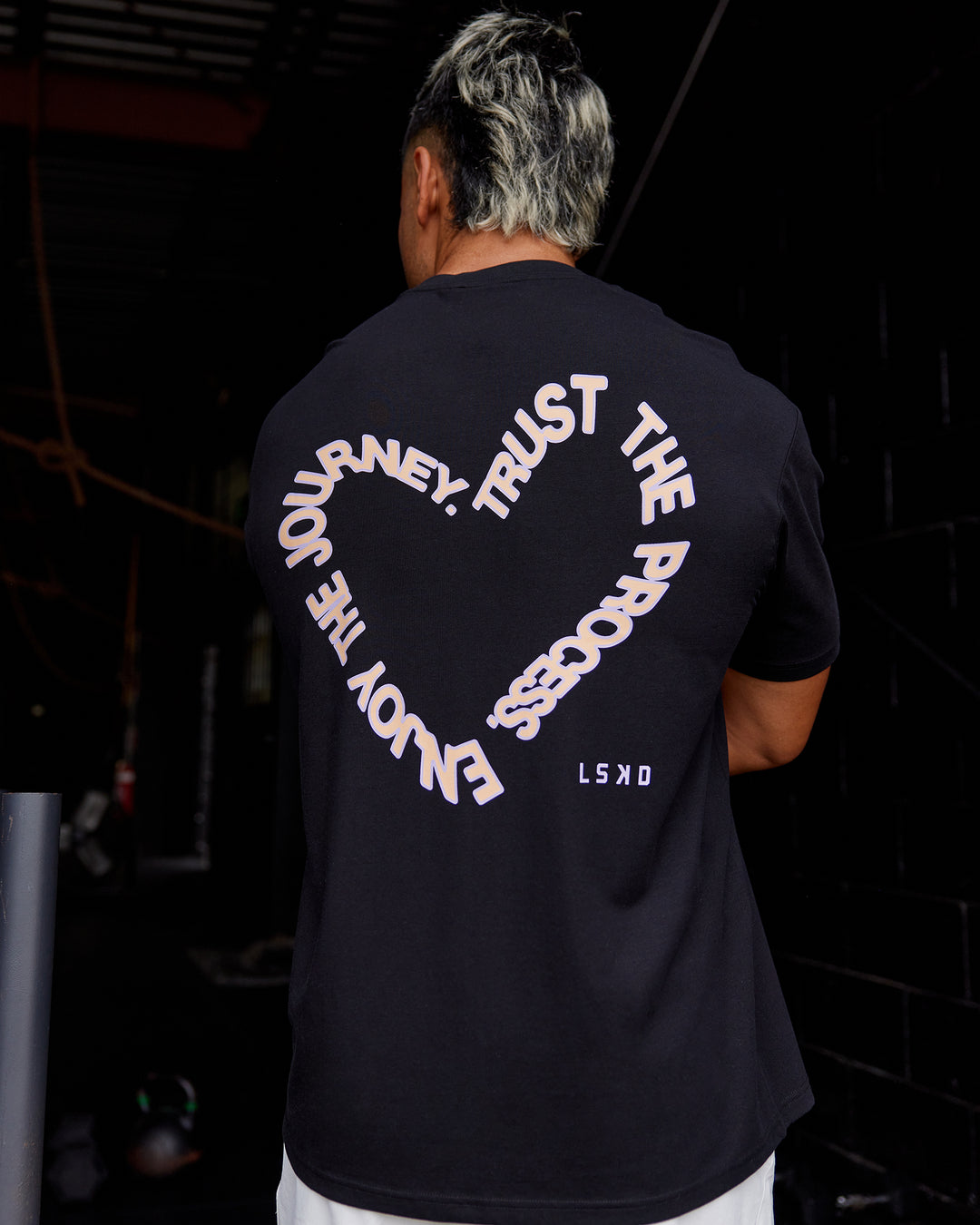 Man wearing Love The Process FLXCotton Oversize Tee - Black-Peach Fuzz | Model:Moses | Size:L