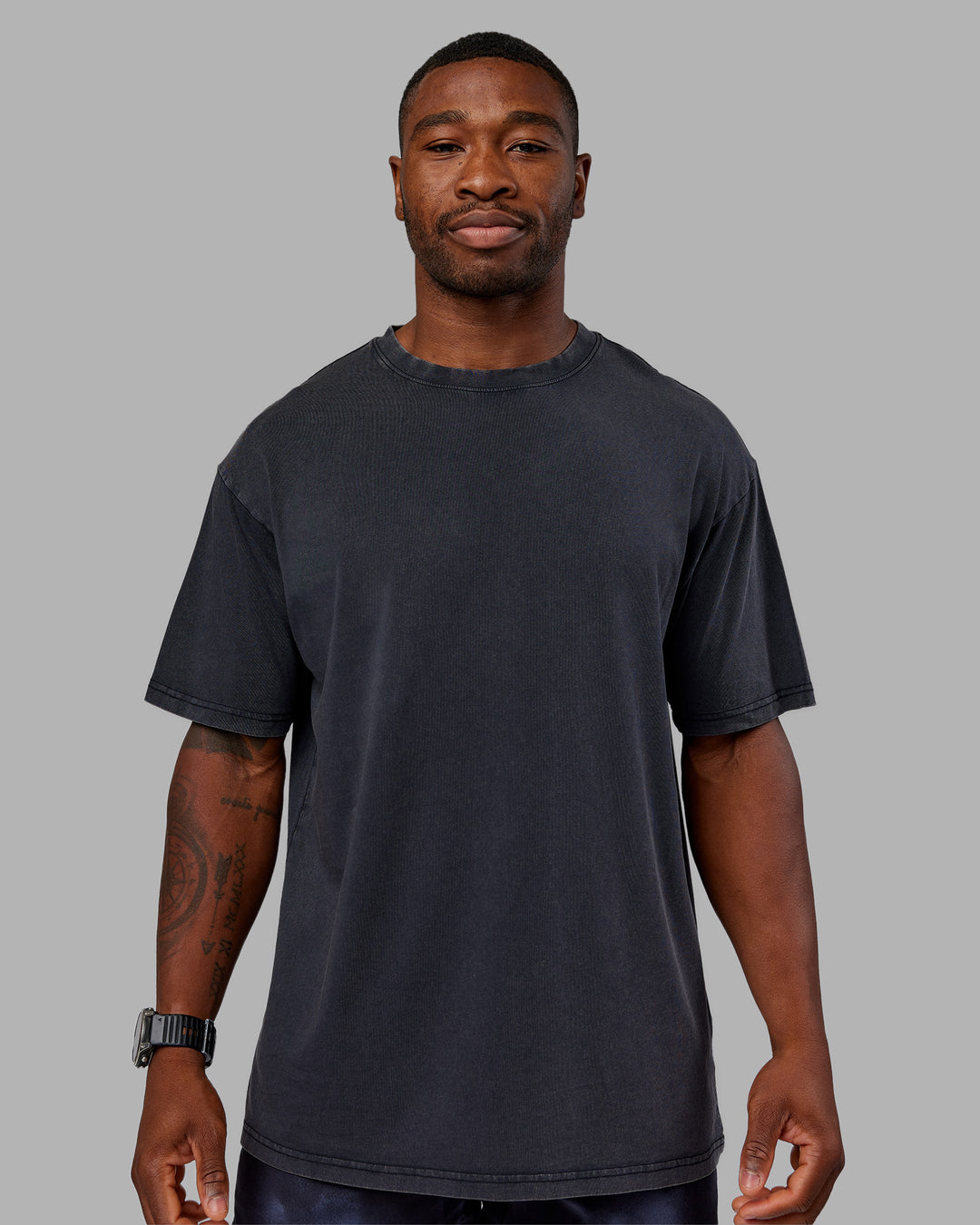 Man wearing Love The Run FLXCotton Tee Oversize - Black Washed-Circular Grey | Model:Sam | Size:L