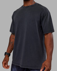 Man wearing Love The Run FLXCotton Tee Oversize - Black Washed-Circular Grey | Model:Sam | Size:L