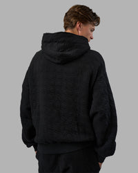 Man wearing MVP Quilted Oversized Hoodie - Black-Geometric | Model:Brandon | Size:L