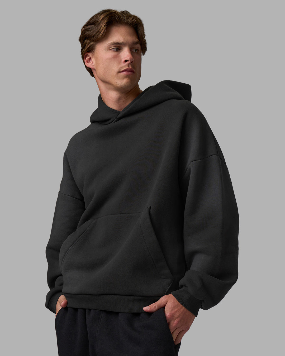 Man wearing Memory In Motion 500gsm Ultra Heavyweight Washed Hoodie - Charcoal Washed | Model:Brandon | Size:L