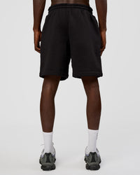 Man wearing Memory In Motion Heavyweight Fleece 7" Short - Black Washed | Model:Okello | Size:L