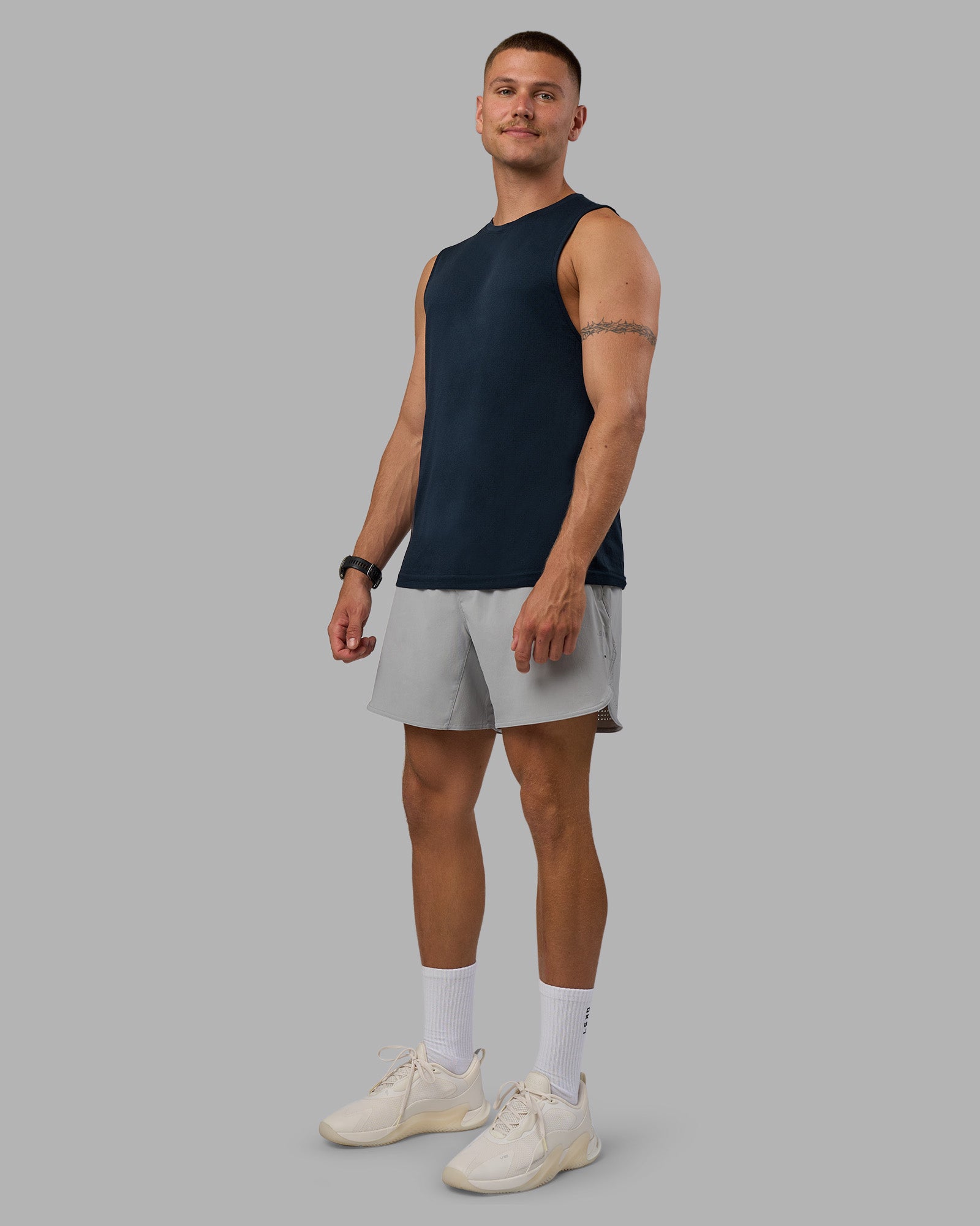 Man wearing AeroFLX+ Seamless Muscle Tank - Navy/Navy | Model:Nikola | Size:L