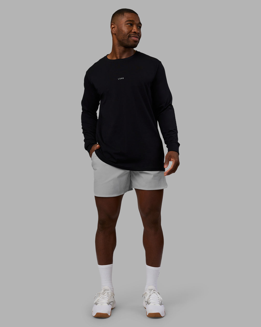 Man wearing Base FLXCotton Long Sleeve Tee - Black | Model:Sam | Size:L