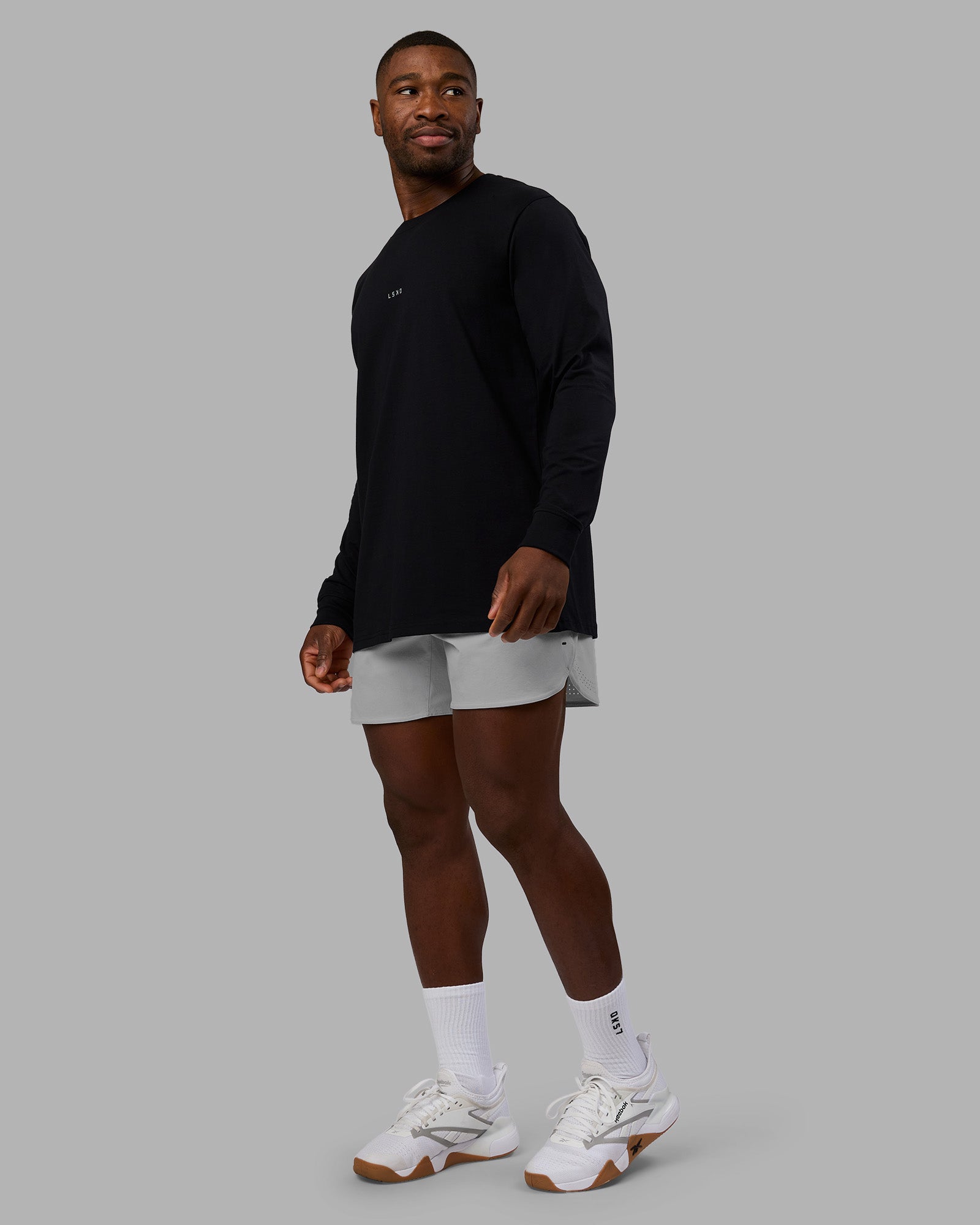 Man wearing Base FLXCotton Long Sleeve Tee - Black | Model:Sam | Size:L