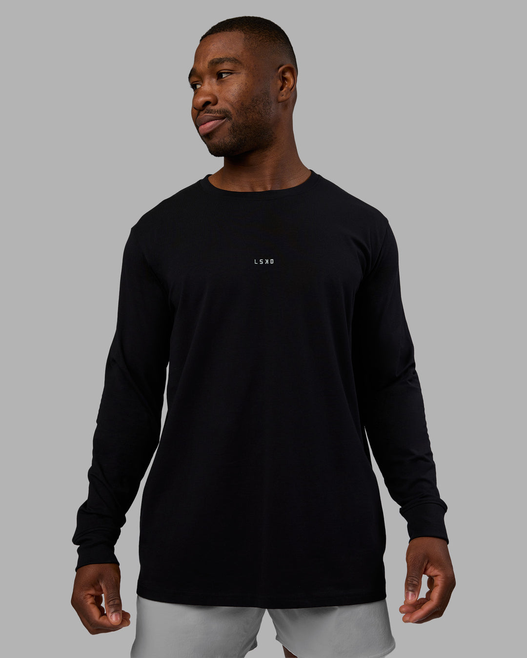 Man wearing Base FLXCotton Long Sleeve Tee - Black | Model:Sam | Size:L