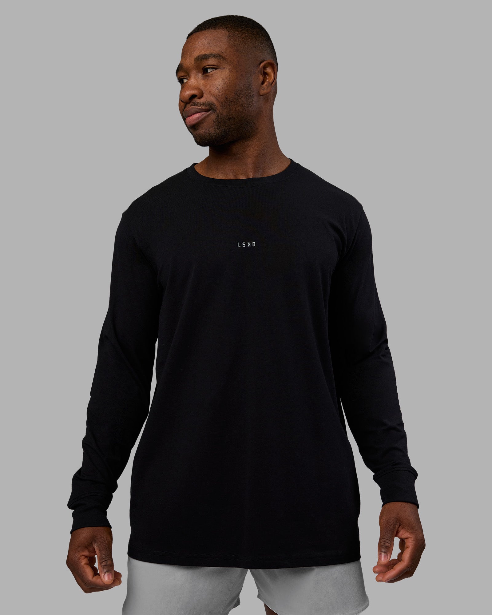 Man wearing Base FLXCotton Long Sleeve Tee - Black | Model:Sam | Size:L