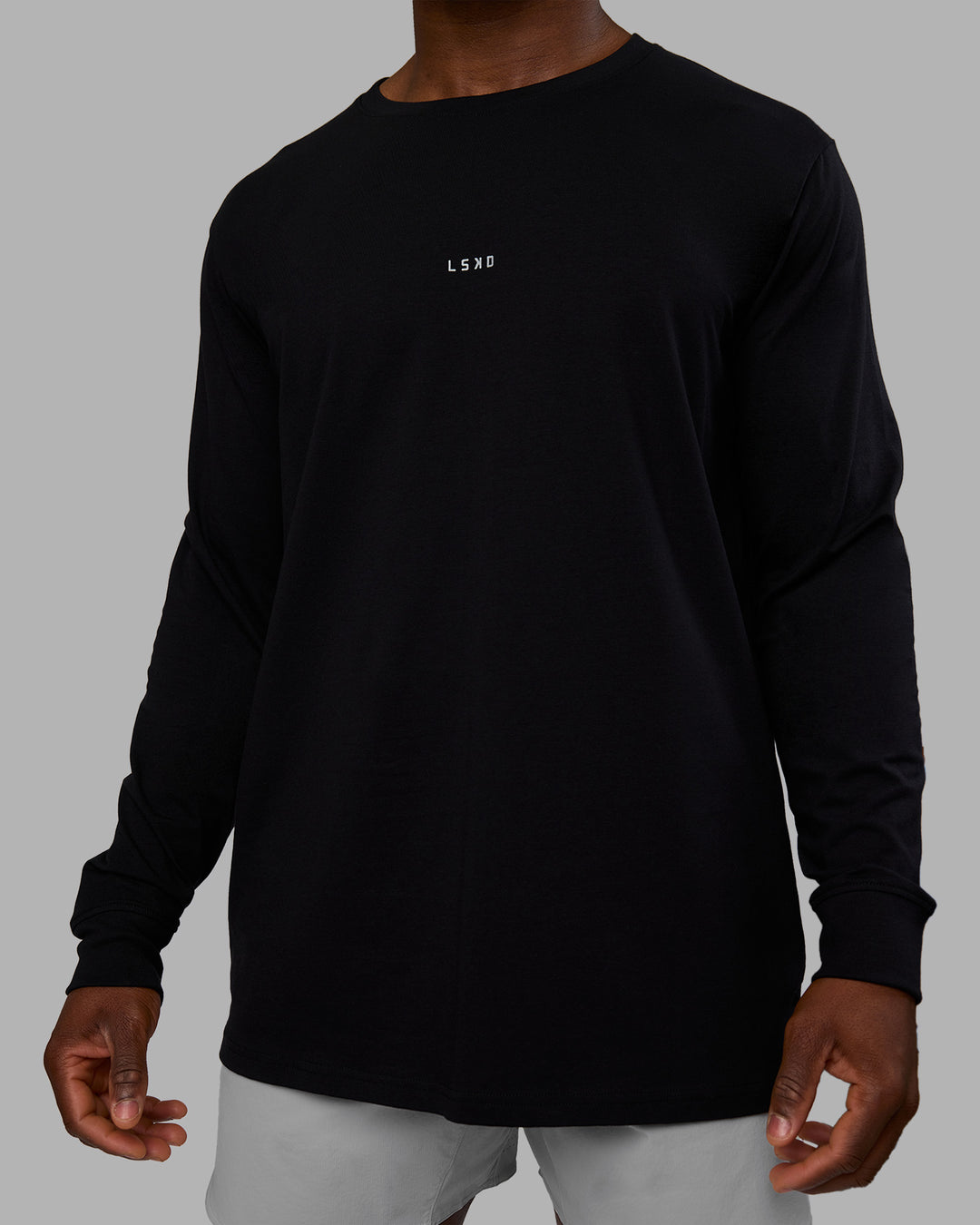 Man wearing Base FLXCotton Long Sleeve Tee - Black | Model:Sam | Size:L