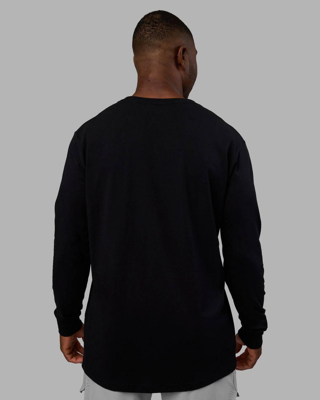 Man wearing Base FLXCotton Long Sleeve Tee - Black | Model:Sam | Size:L