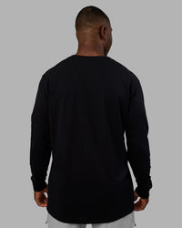 Man wearing Base FLXCotton Long Sleeve Tee - Black | Model:Sam | Size:L