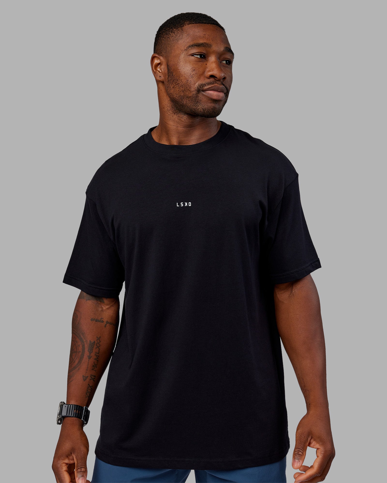 Man wearing Base FLXCotton Tee Oversized - Black | Model:Sam | Size:L