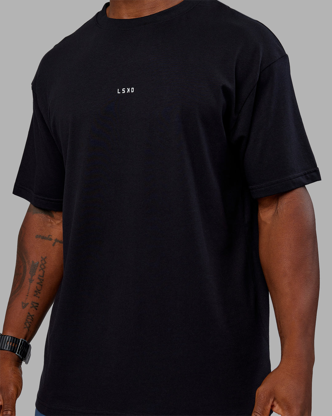 Man wearing Base FLXCotton Tee Oversized - Black | Model:Sam | Size:L