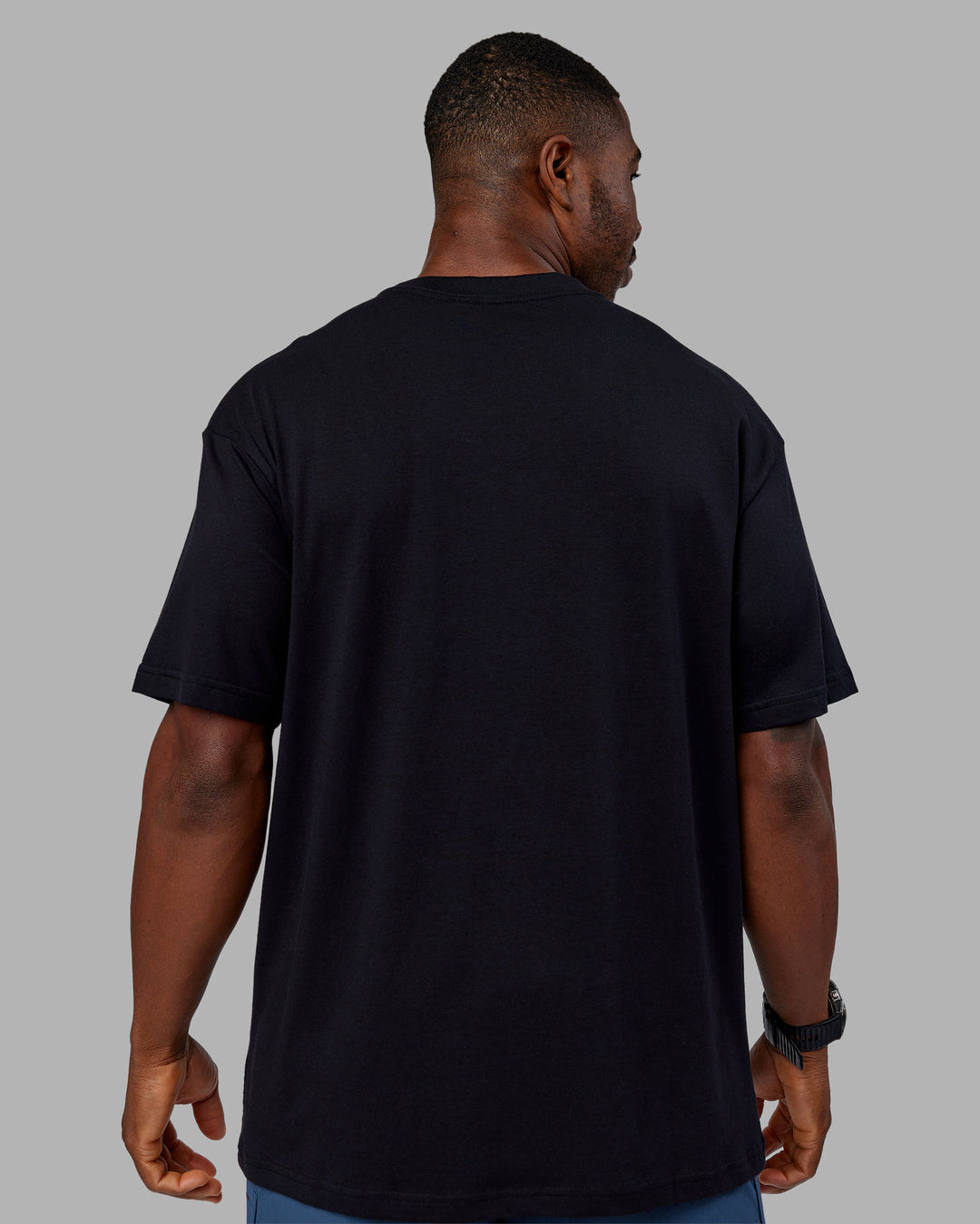 Man wearing Base FLXCotton Tee Oversized - Black | Model:Sam | Size:L
