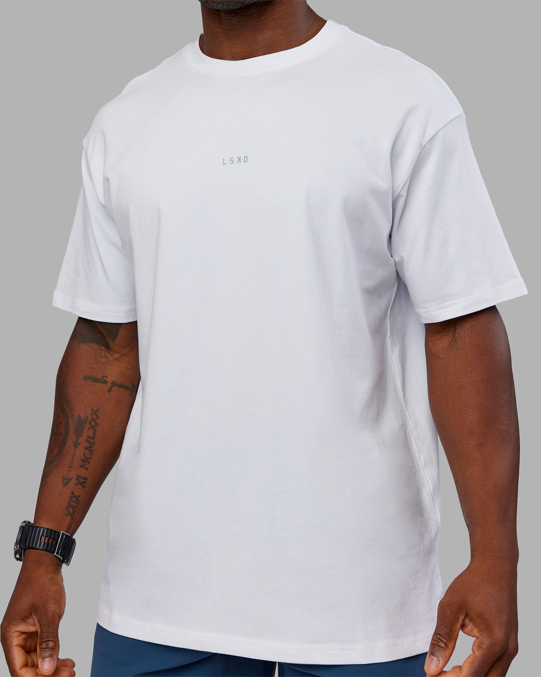 Man wearing Base FLXCotton Tee Oversized - White | Model:Sam | Size:L