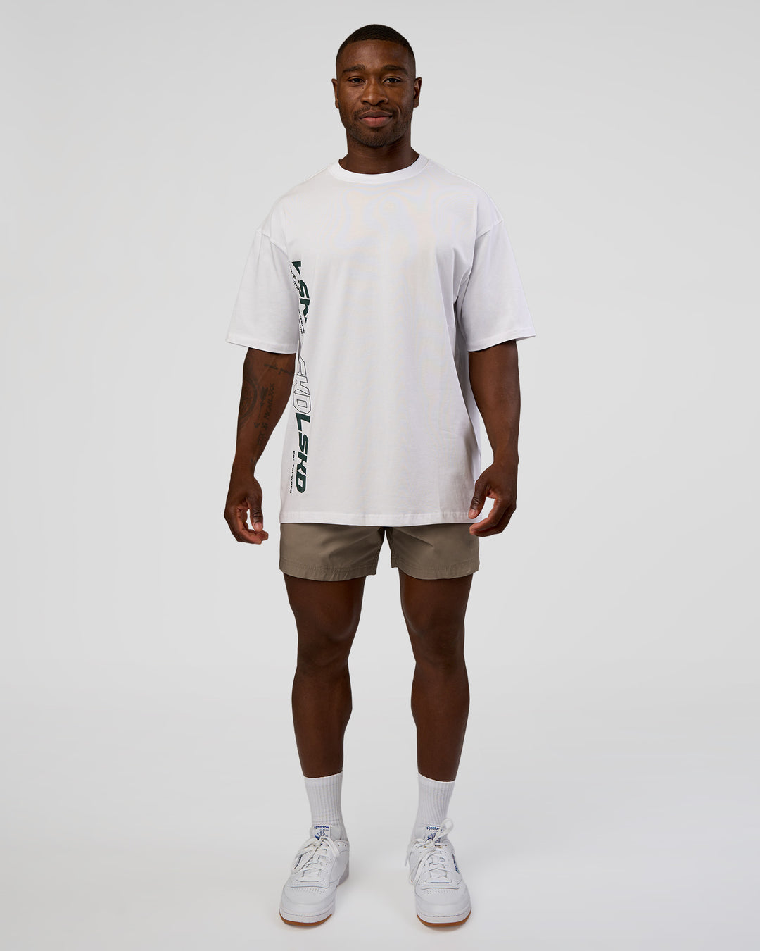 Man wearing Nothing Is Impossible FLXCotton Oversized Tee - White-Vital Green | Model:Sam | Size:L