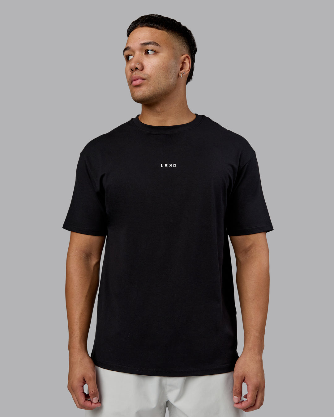 Man wearing On Repeat FLXCotton Oversized Tee - Black-White | Model:Kaelyb | Size:L