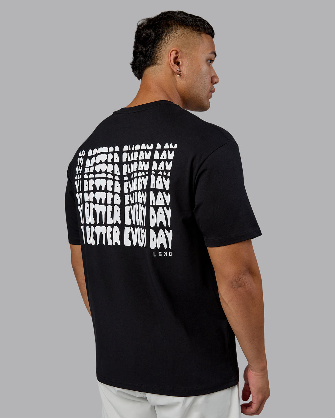 Man wearing On Repeat FLXCotton Oversized Tee - Black-White | Model:Kaelyb | Size:L