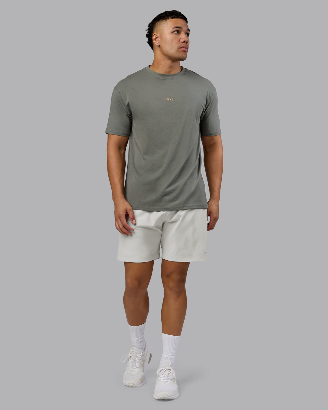 Man wearing On Repeat FLXCotton Oversized Tee - Graphite-Warm Apricot | Model:Kaelyb | Size:L