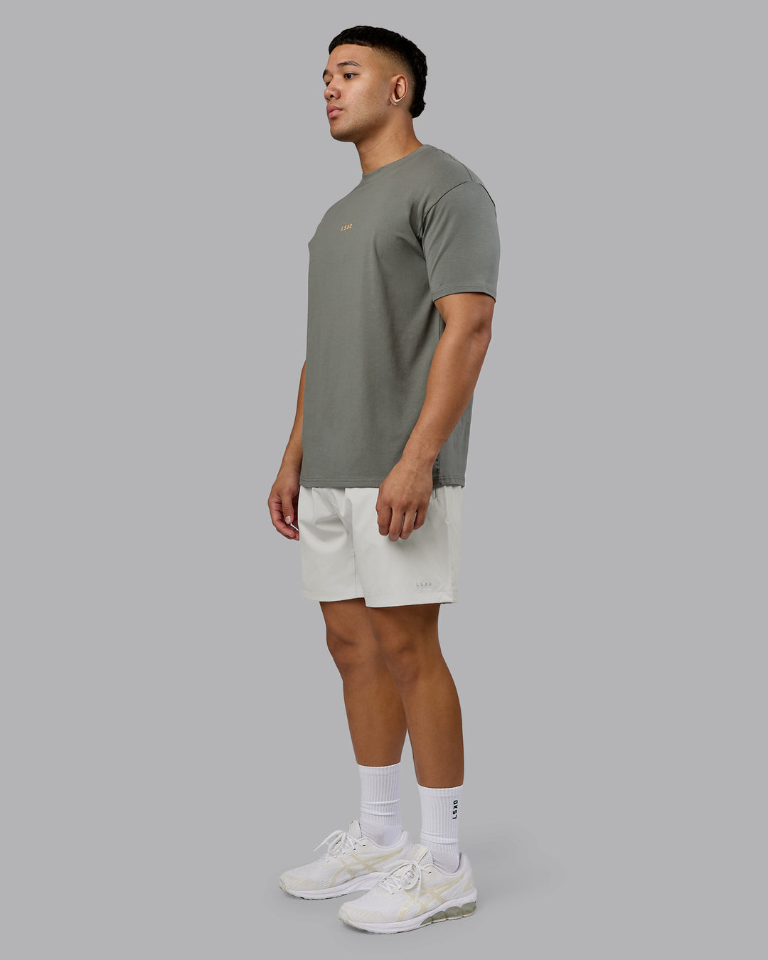 Man wearing On Repeat FLXCotton Oversized Tee - Graphite-Warm Apricot | Model:Kaelyb | Size:L