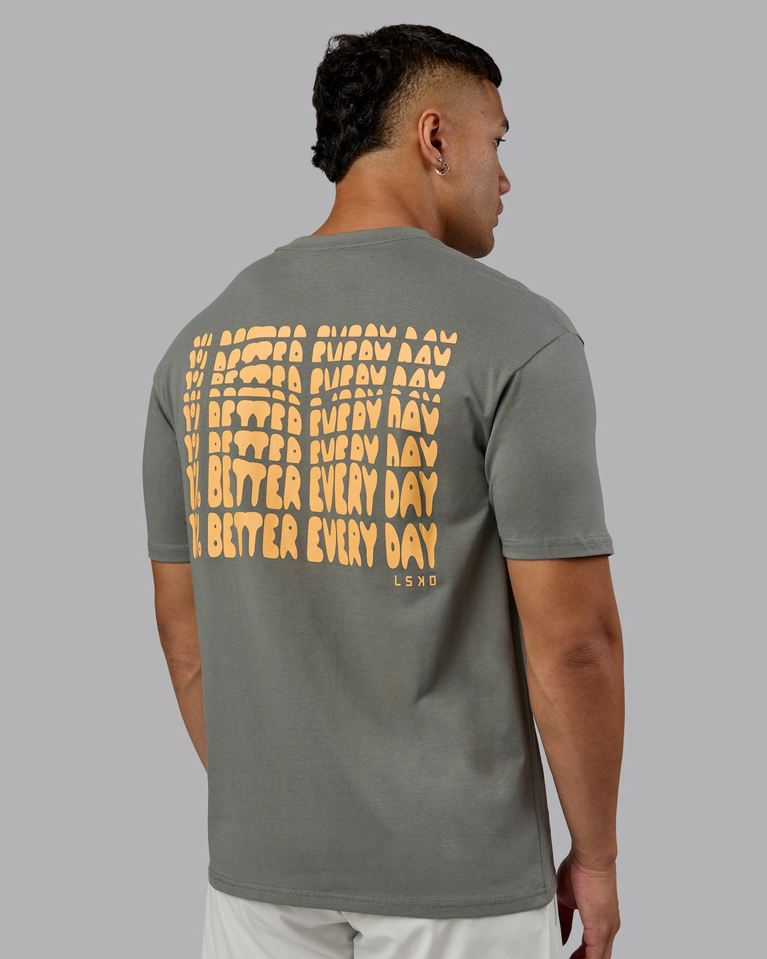 Man wearing On Repeat FLXCotton Oversized Tee - Graphite-Warm Apricot | Model:Kaelyb | Size:L