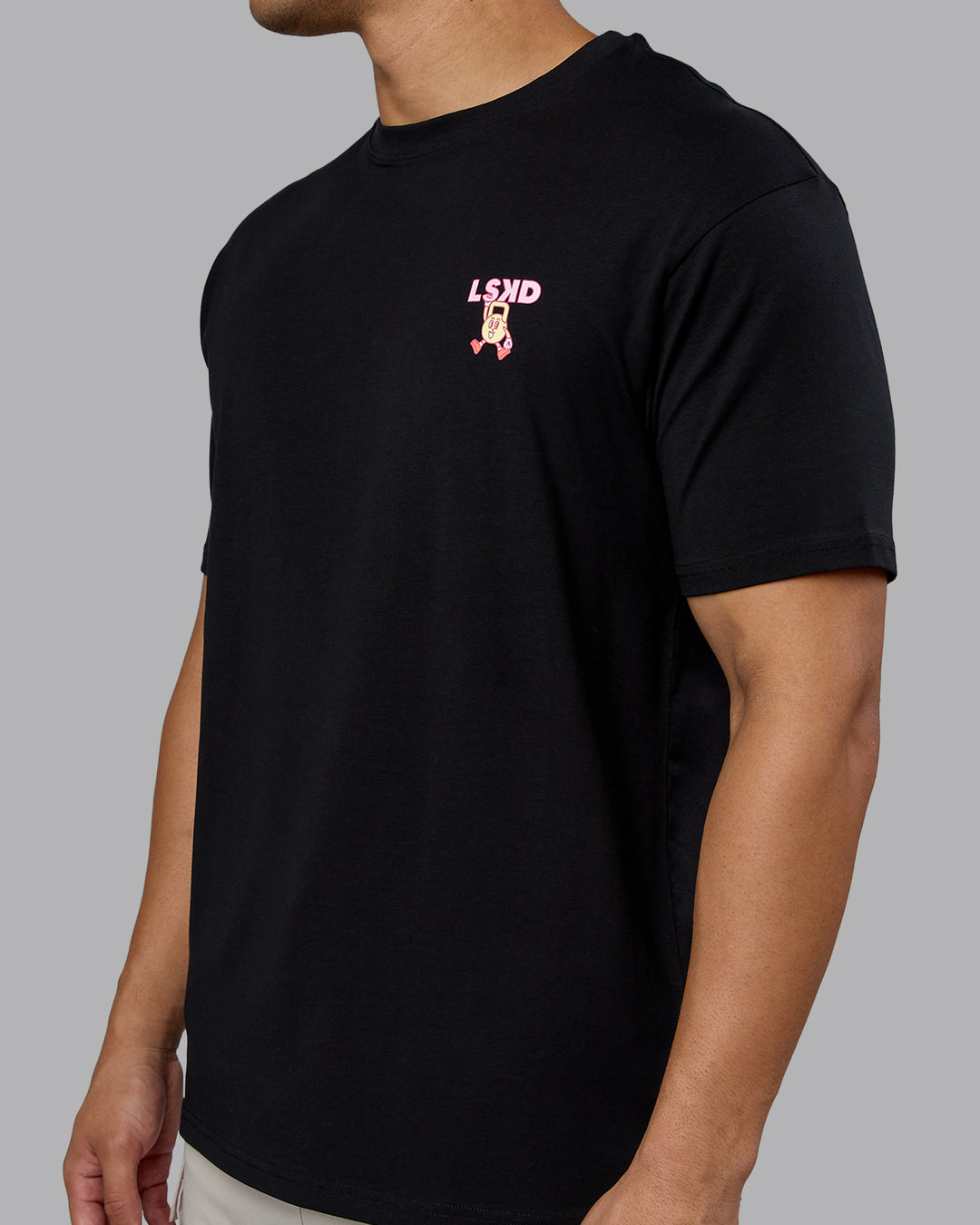 Man wearing Perspective FLXCotton Oversized Tee - Black-Soft Pink | Model:Kaelyb | Size:L