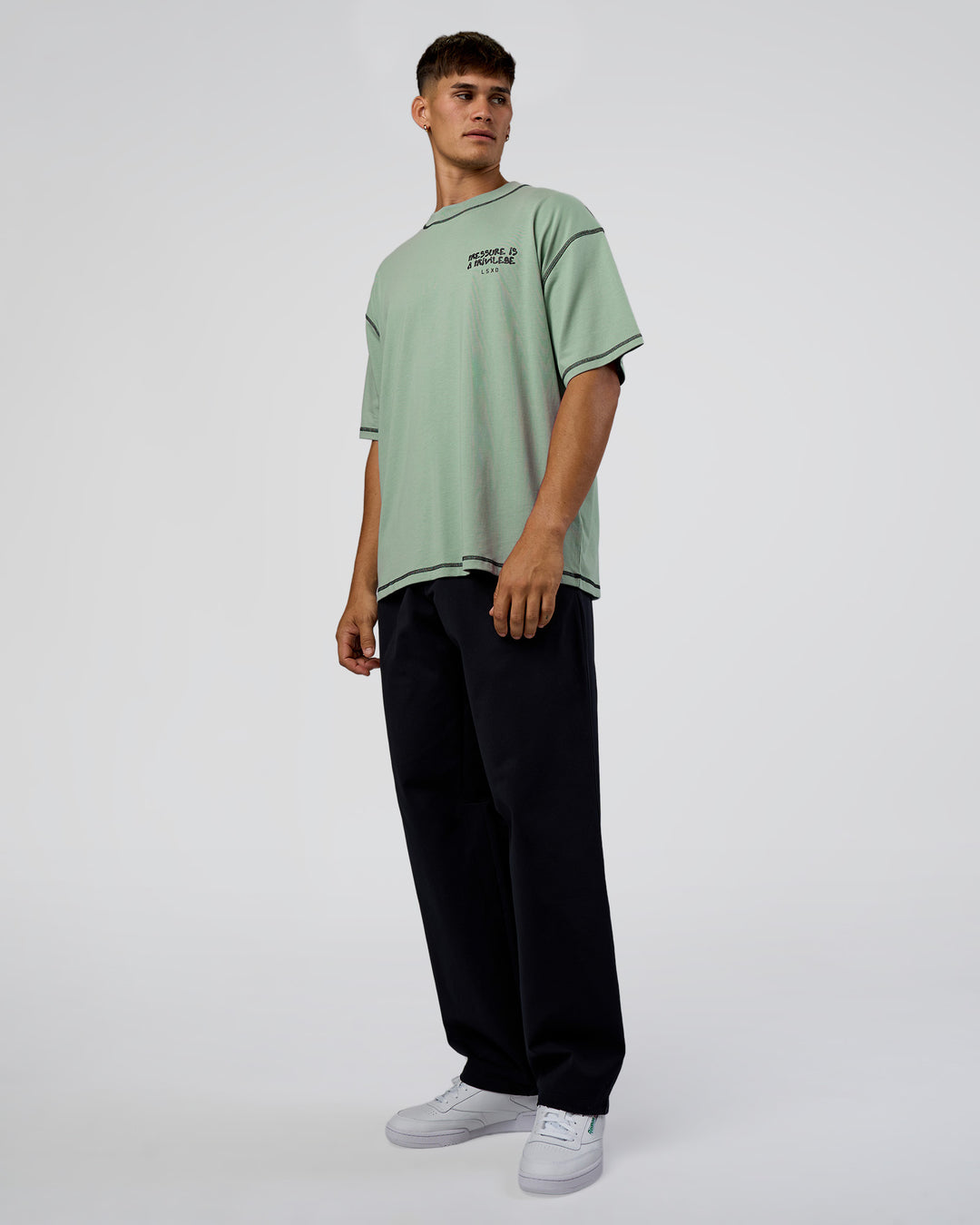 Man wearing Pressure is Privilege Oversized Tee - Iceberg Green-Black | Model:Jackson | Size:L