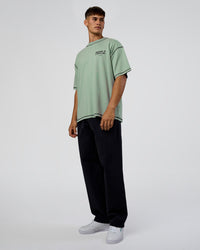 Man wearing Pressure is Privilege Oversized Tee - Iceberg Green-Black | Model:Jackson | Size:L