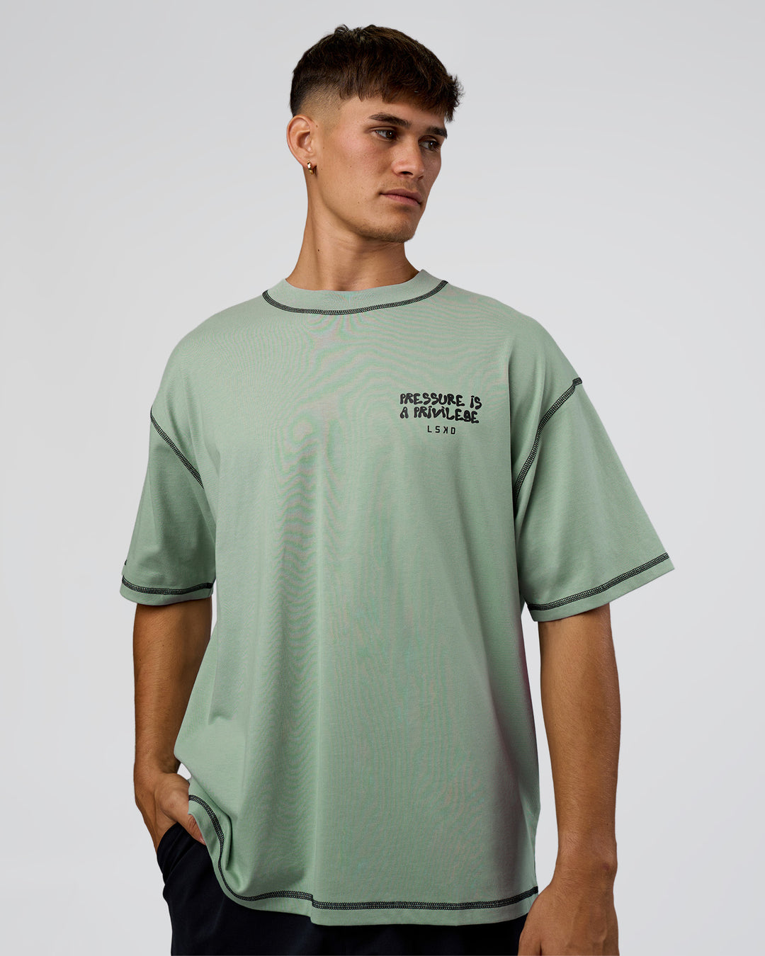 Man wearing Pressure is Privilege Oversized Tee - Iceberg Green-Black | Model:Jackson | Size:L