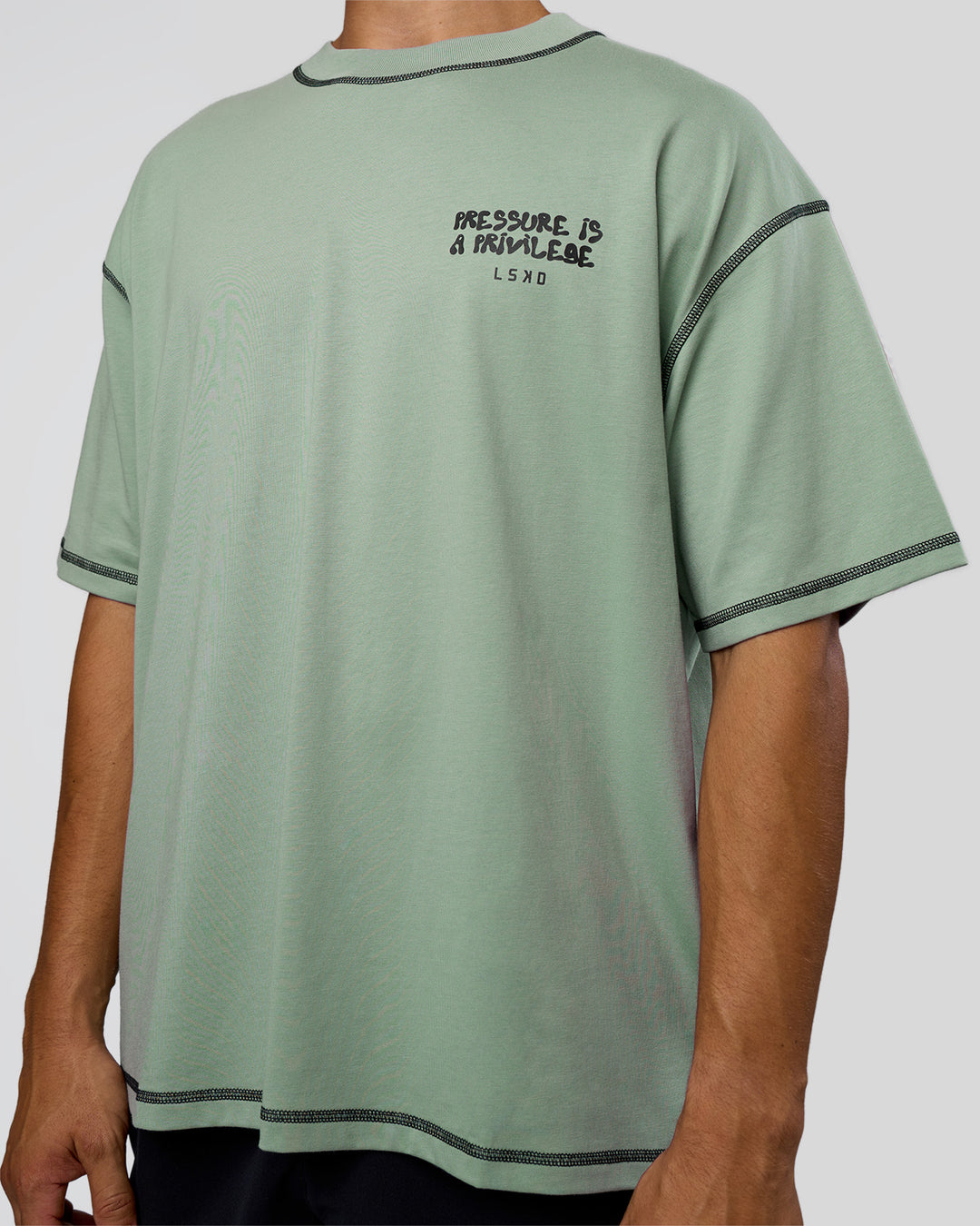Man wearing Pressure is Privilege Oversized Tee - Iceberg Green-Black | Model:Jackson | Size:L
