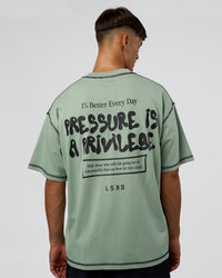 Man wearing Pressure is Privilege Oversized Tee - Iceberg Green-Black | Model:Jackson | Size:L
