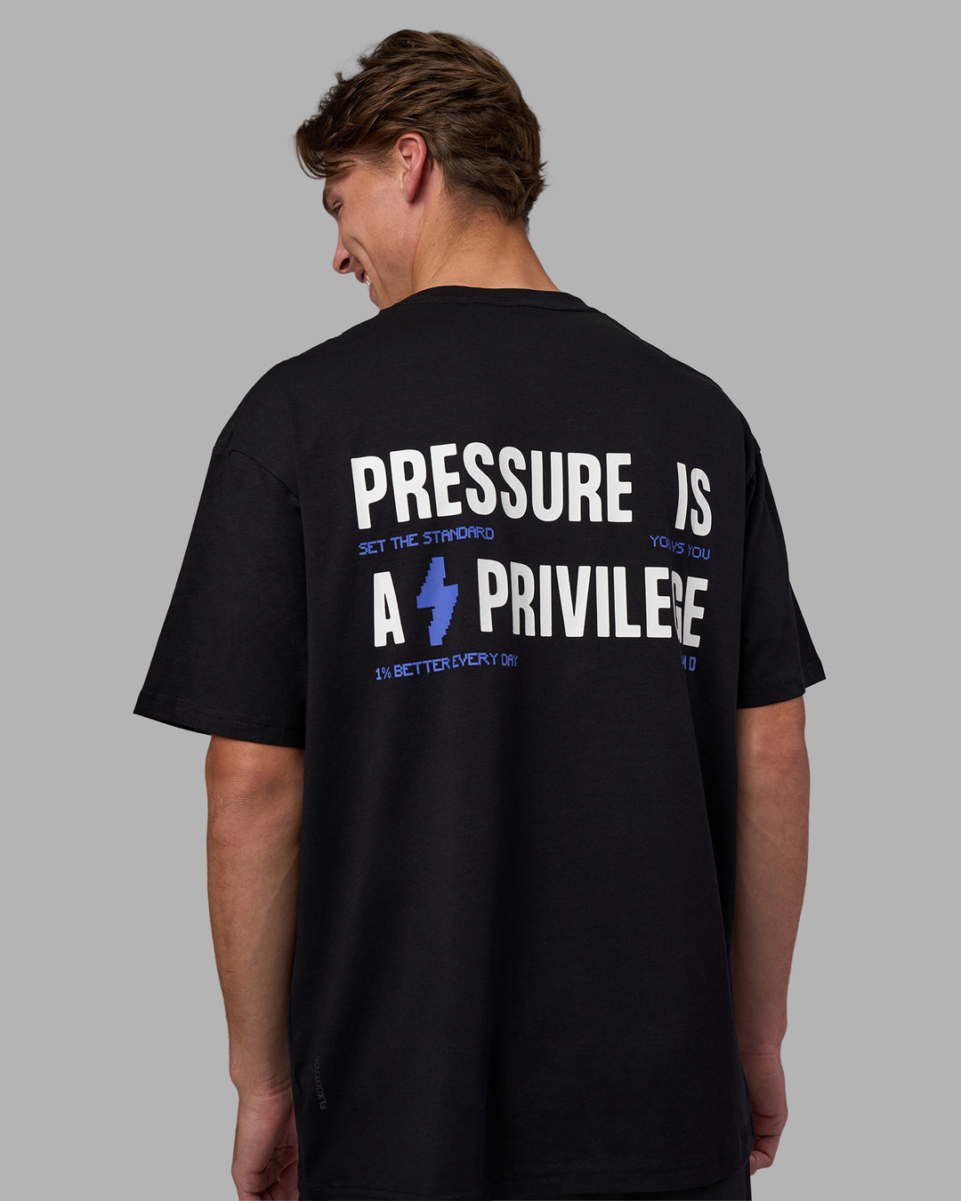 Man wearing Pressure is a Privilege FLXCotton Oversized Tee - Black-Power Cobalt | Model:Brandon | Size:L