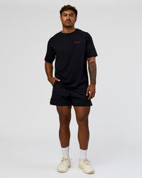 Man wearing RUN CLUB FLXCotton Tee Oversize - Black-Scarlet | Model:Xav | Size:L 