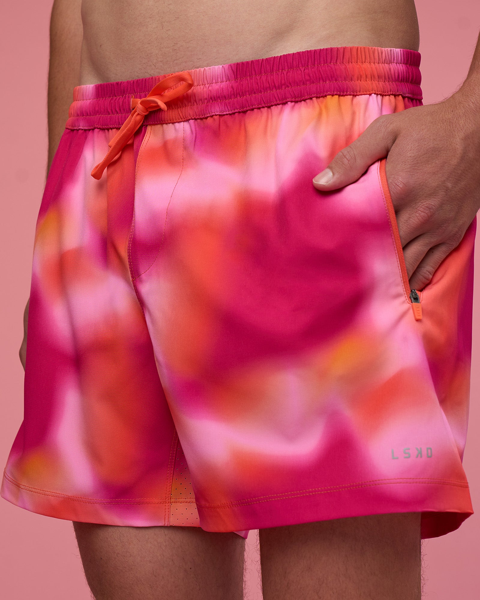 Man wearing Rep 5" Performance Short - Pink Glow Print | Model:Brandon | Size:L
