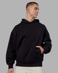 Man wearing Rise & Lift Hoodie Oversized - Black-White | Model:Tom | Size:L