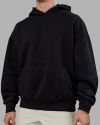 Man wearing Rise & Lift Hoodie Oversized - Black-White | Model:Tom | Size:L